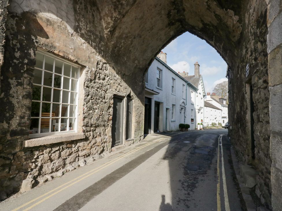 An archway with buildings and a road at No.2 The Flags, Grange-over-Sands