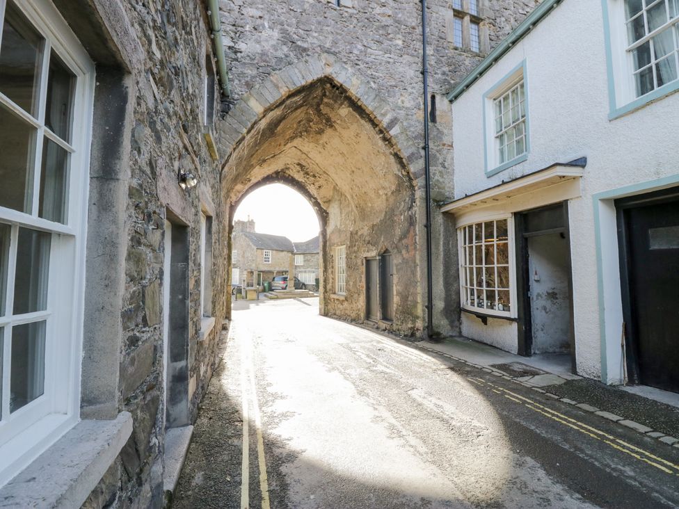 An archway leading to a street with buildings at No.2 The Flags, Grange-over-Sands