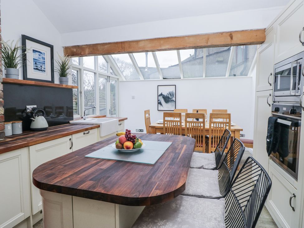 A kitchen with a dining area and a kitchen island at No.2 The Flags in Cartmel
