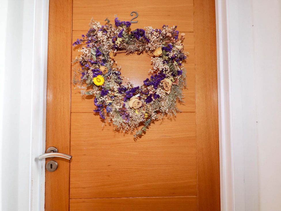 A door with a flower wreath and a number 2 at 2 Morweth View in Torpoint