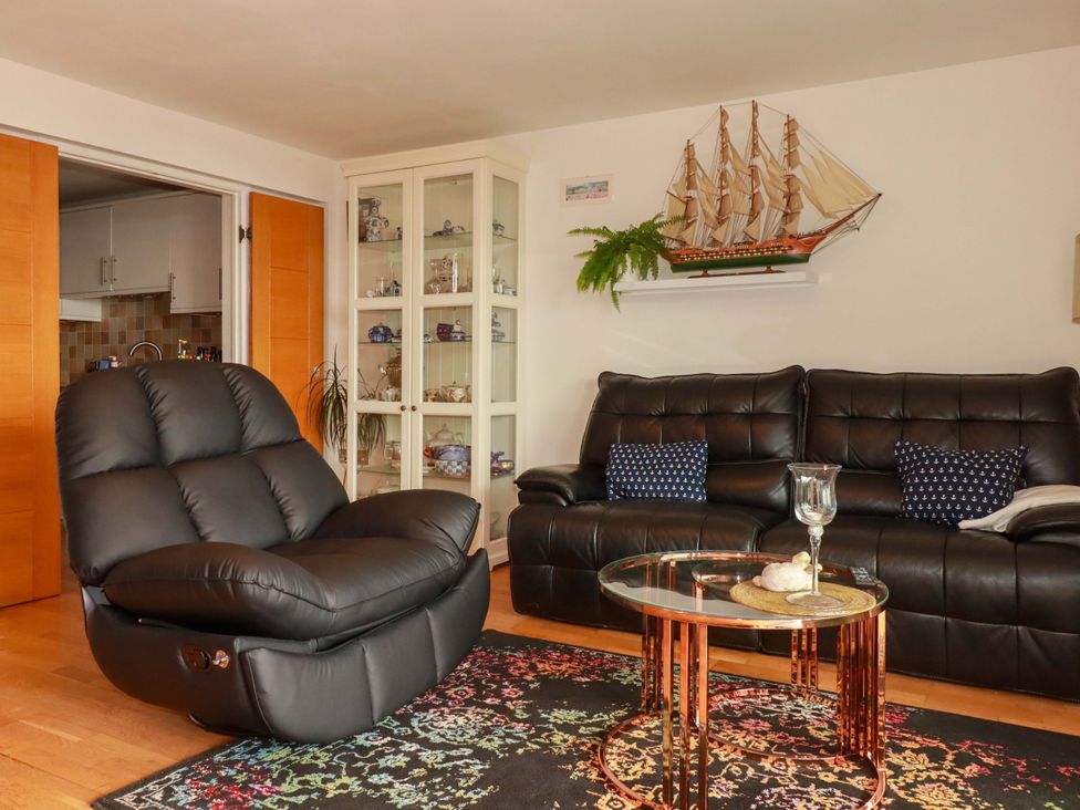 A living room with a recliner chair and a coffee table at 2 Morweth View in Torpoint