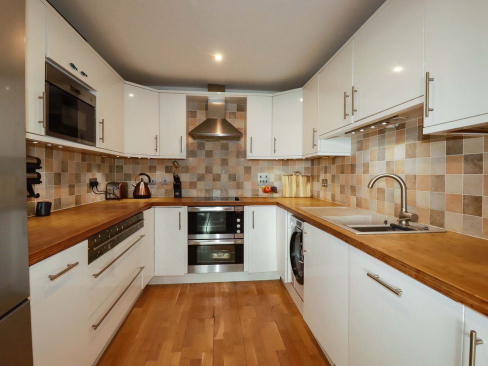 A kitchen with cabinets and appliances at 2 Morweth View in Torpoint