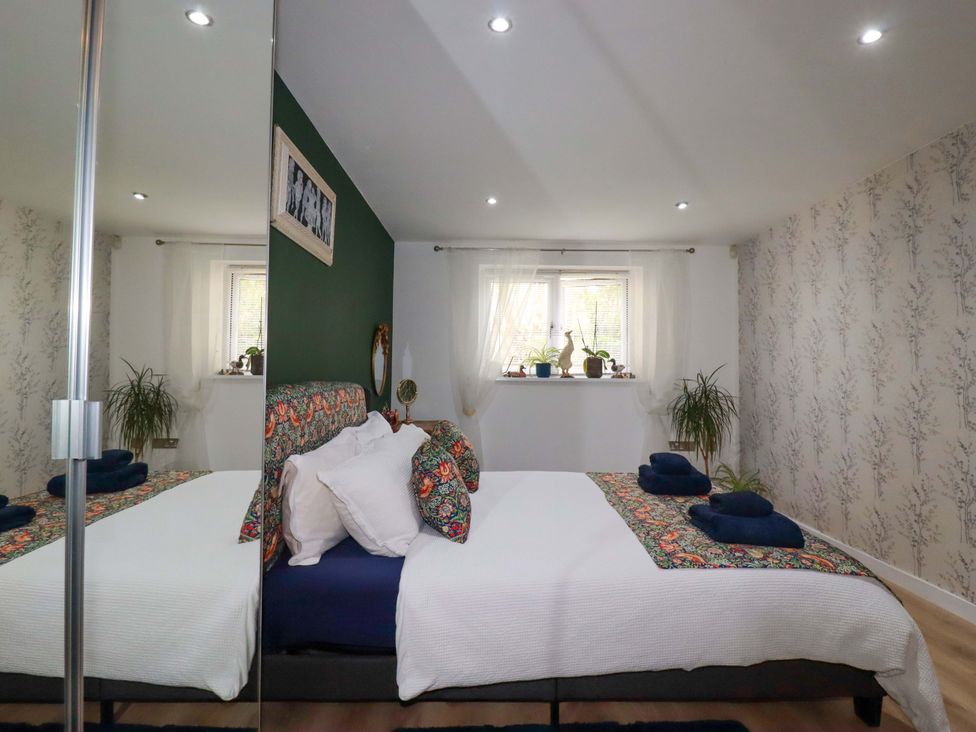 A bedroom with a bed and window at 2 Morweth View Torpoint