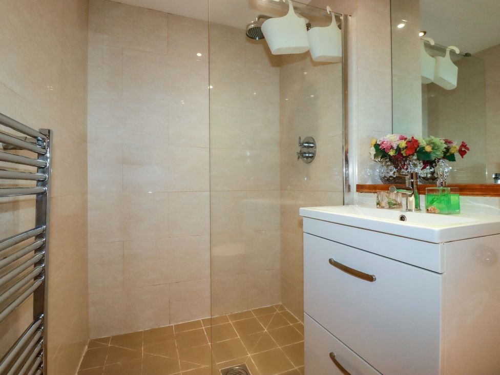 A bathroom with a shower and sink at 2 Morweth View in Torpoint