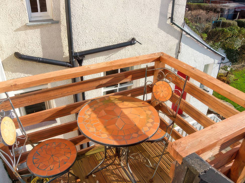 A balcony with a table and chairs at Morlais in Rhosneigr