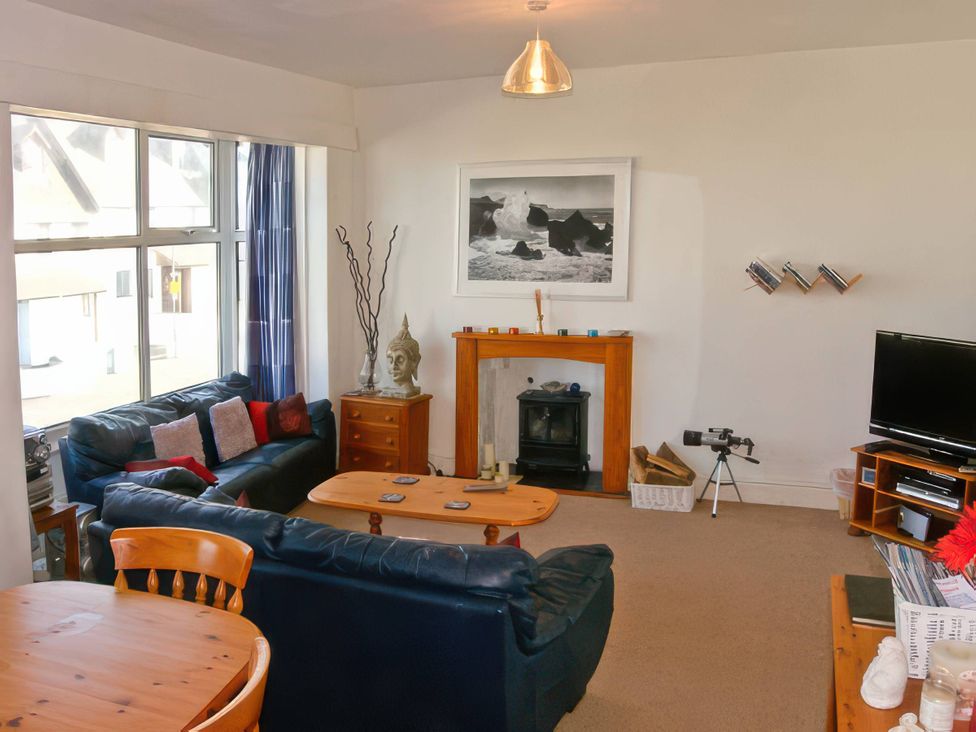 A living room with a sofa and coffee table at Morlais in Rhosneigr