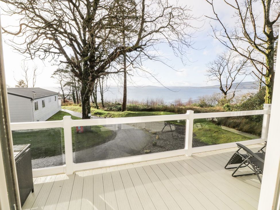 An outdoor area with decking and trees at Serenity Lodge in Wemyss Bay