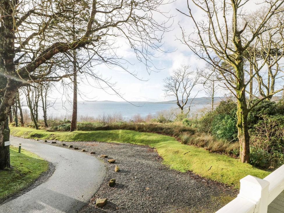 A view of a winding road by the water at Serenity Lodge in Wemyss Bay