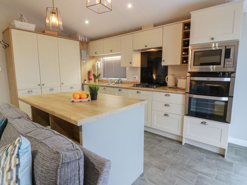 A kitchen with appliances and a countertop at Serenity Lodge in Wemyss Bay