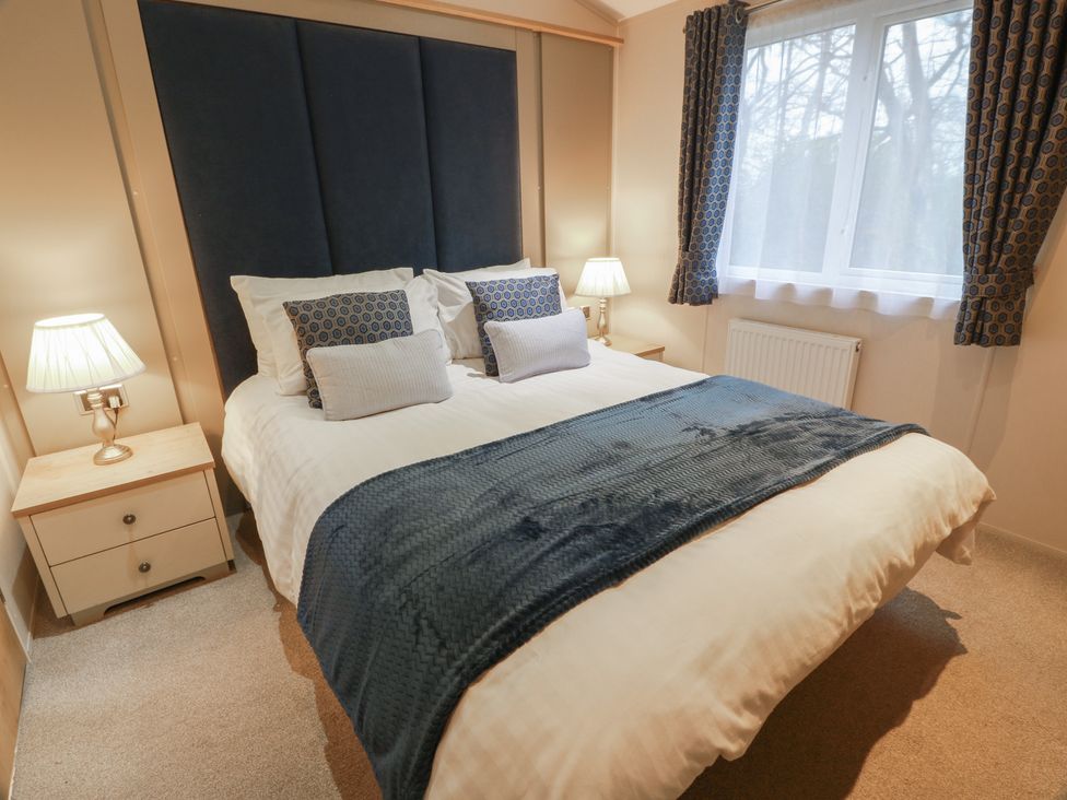 A bedroom with a bed and bedside lamps at Serenity Lodge in Wemyss Bay
