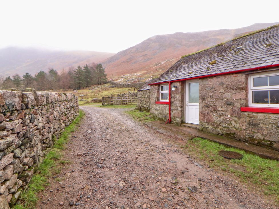 A stone cottage beside a dirt road at Easthwaite Cottage Holmrook near Easthwaite Farm