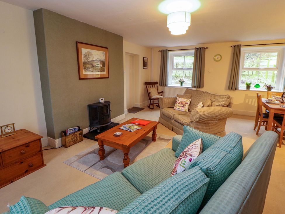A living room with sofa and coffee table at Easthwaite Cottage in Holmrook near Easthwaite Farm