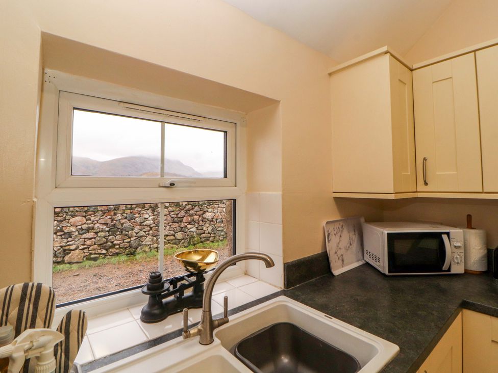 A kitchen with a sink and microwave at Easthwaite Cottage Holmrook near Easthwaite Farm
