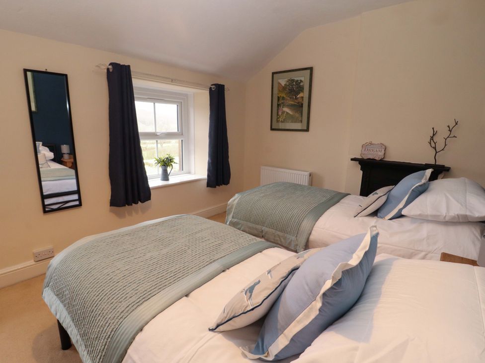 A bedroom with two single beds and a window at Easthwaite Cottage Holmrook near Easthwaite Farm