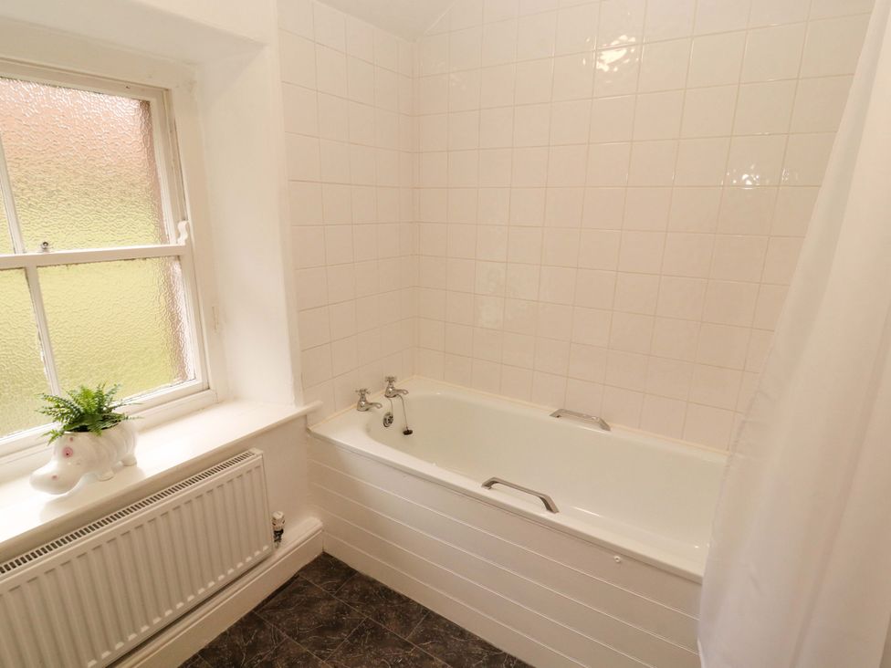 A bathroom with a bathtub and window at Easthwaite Cottage in Holmrook near Easthwaite Farm
