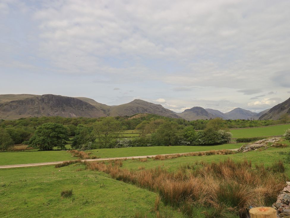 A landscape view of mountains and fields at Easthwaite Cottage in Nether Wasdale near Wastwater