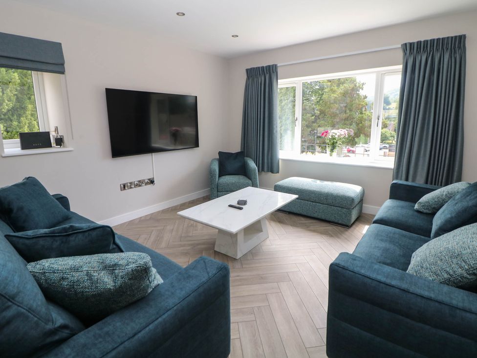 A living room with a television and seating area at The Bungalow in Matlock