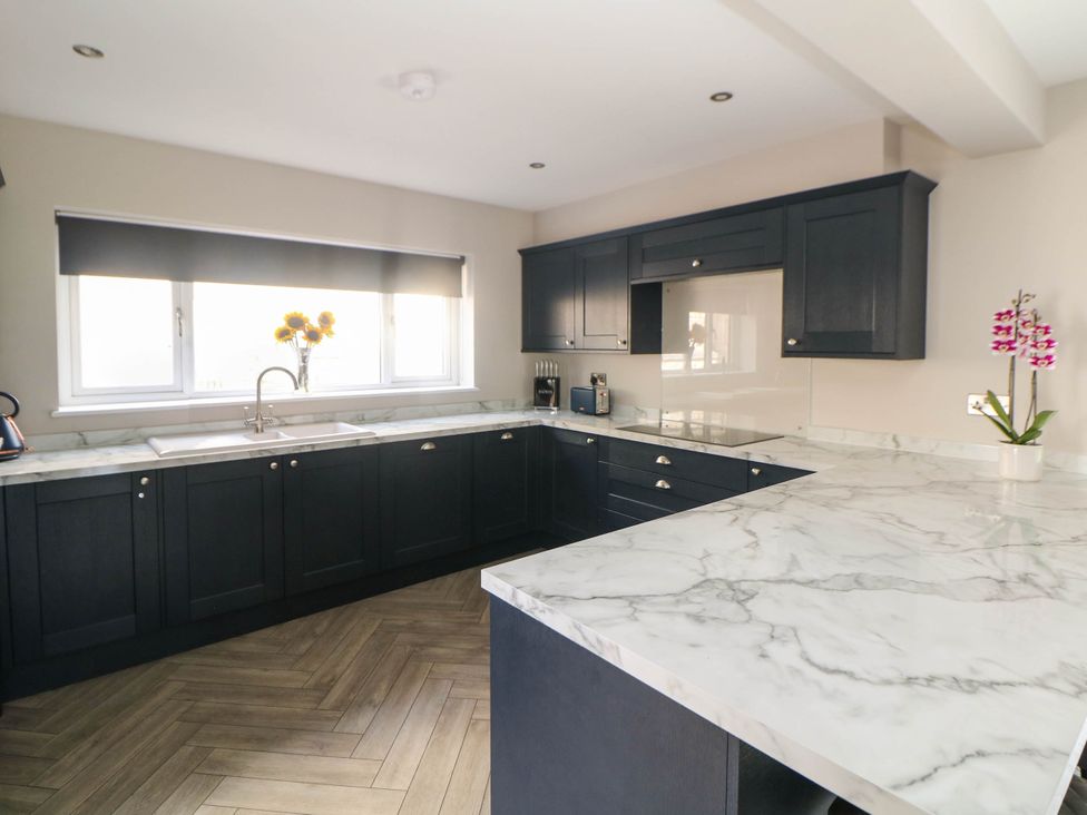 A kitchen with cabinets and a sink at The Bungalow in Matlock