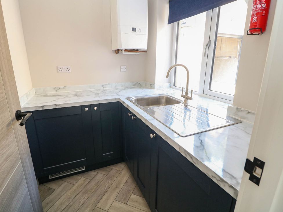 A kitchen with a sink, tap, and worktop at The Bungalow in Matlock