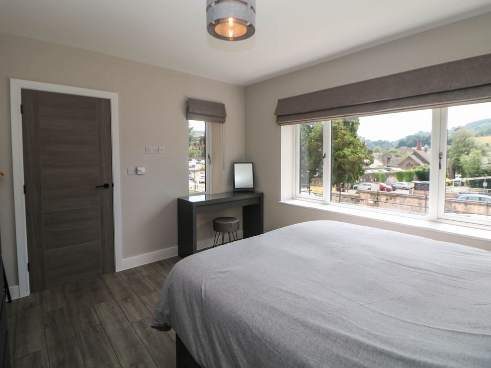A bedroom with a desk and mirror at The Bungalow in Matlock