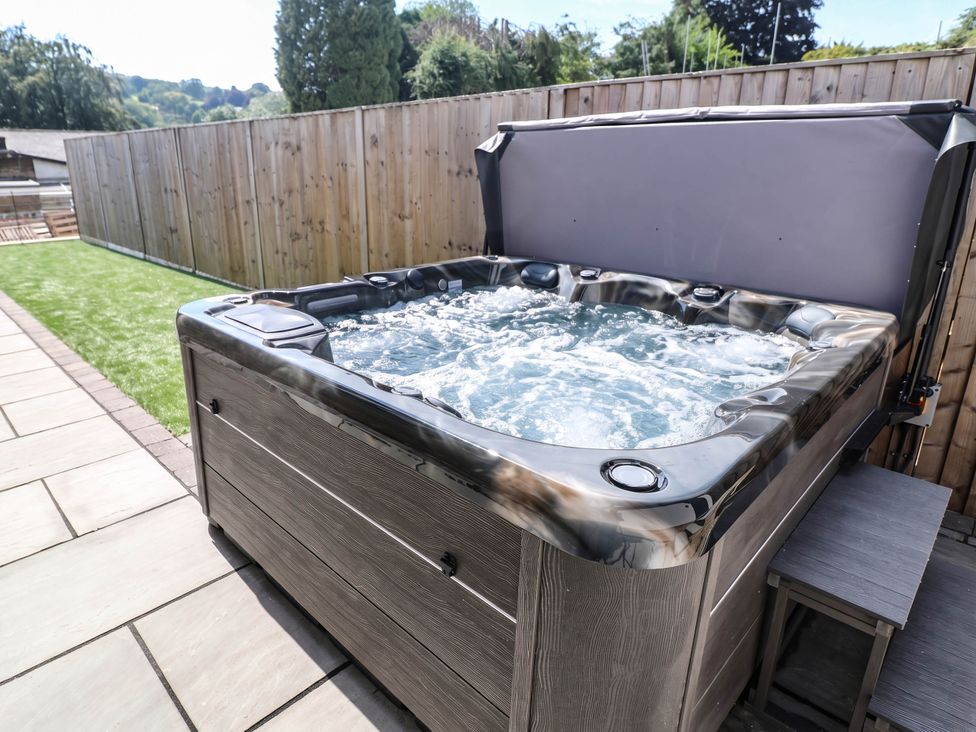 A hot tub on a patio in the garden at The Bungalow in Matlock