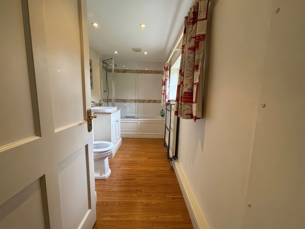 A bathroom with a sink, toilet, and bathtub at New Barn in Broad Chalke