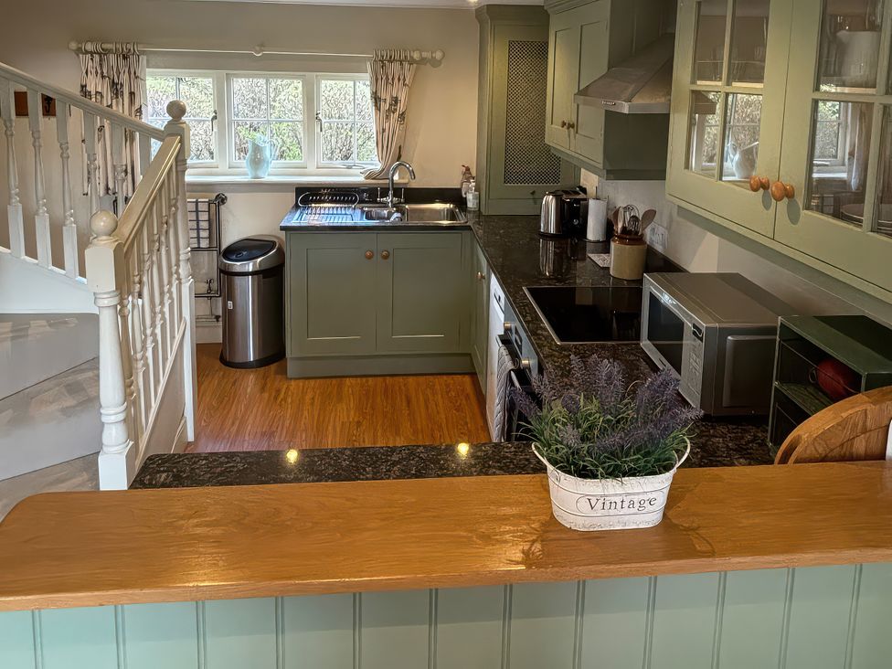 A kitchen with cabinets, sink, and appliances at New Barn in Broad Chalke