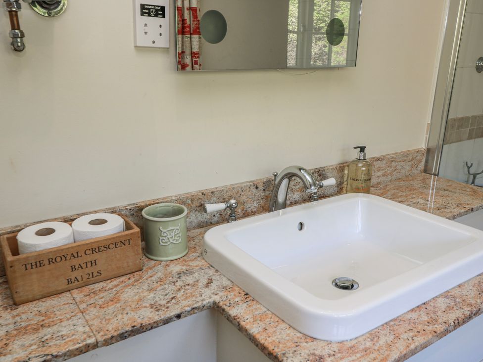 A sink with a tap and soap dispenser at New Barn in Broad Chalke
