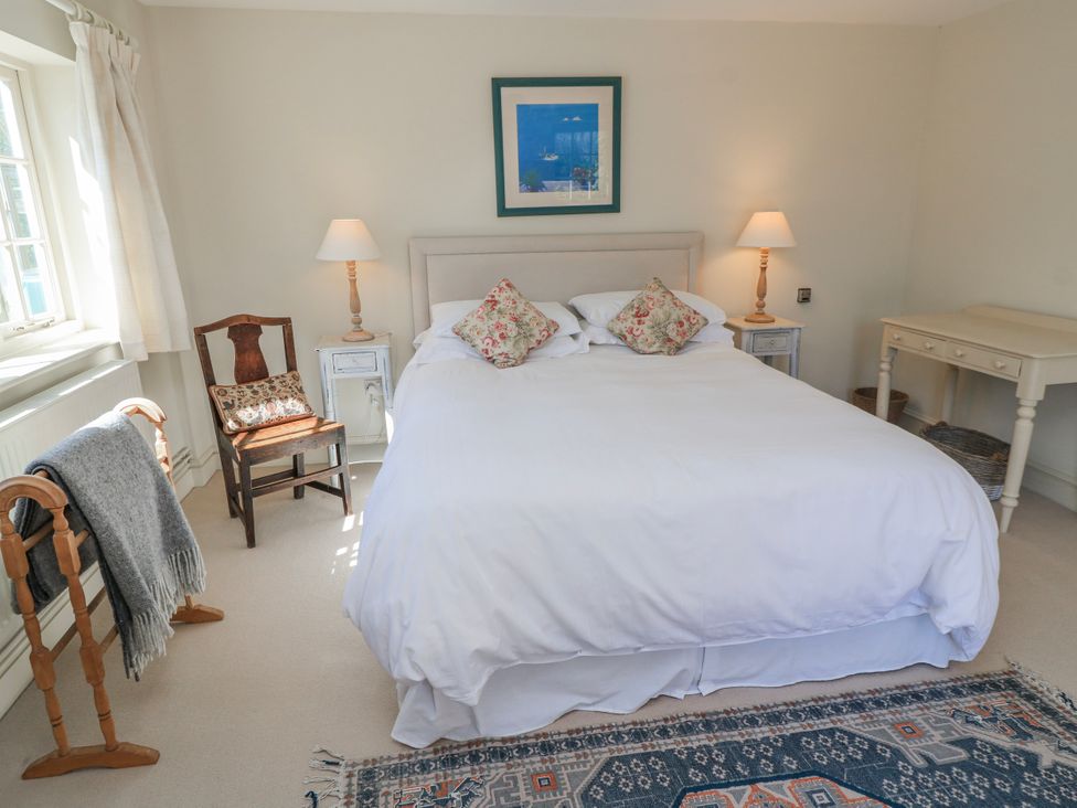 A bedroom with a bed and bedside tables at New Barn in Broad Chalke