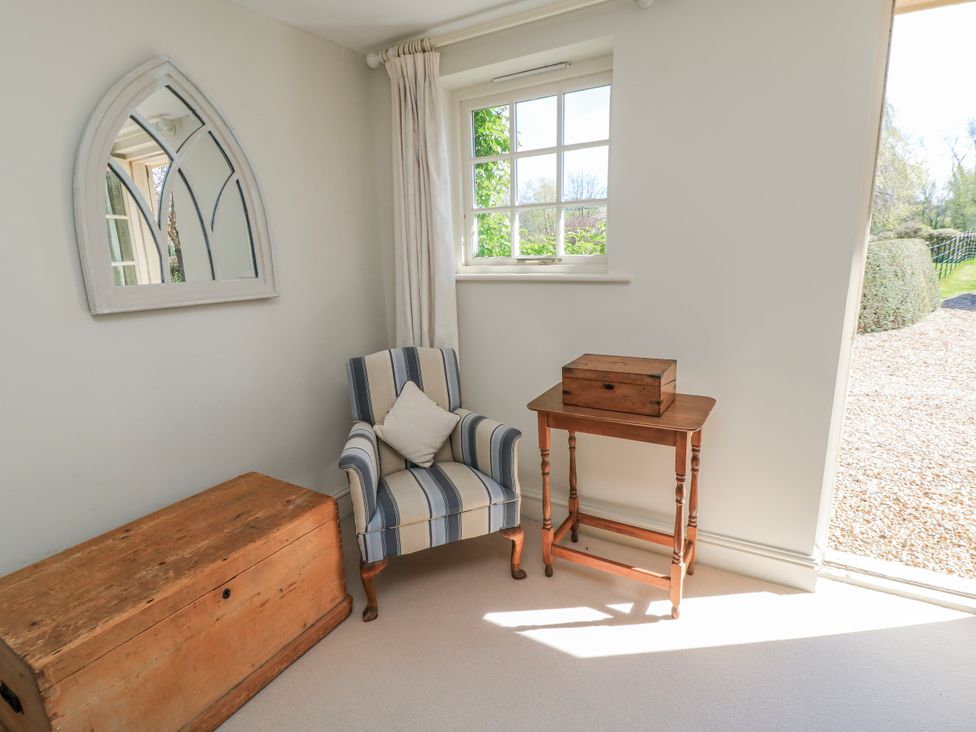 A snug with a chair and table at New Barn in Broad Chalke