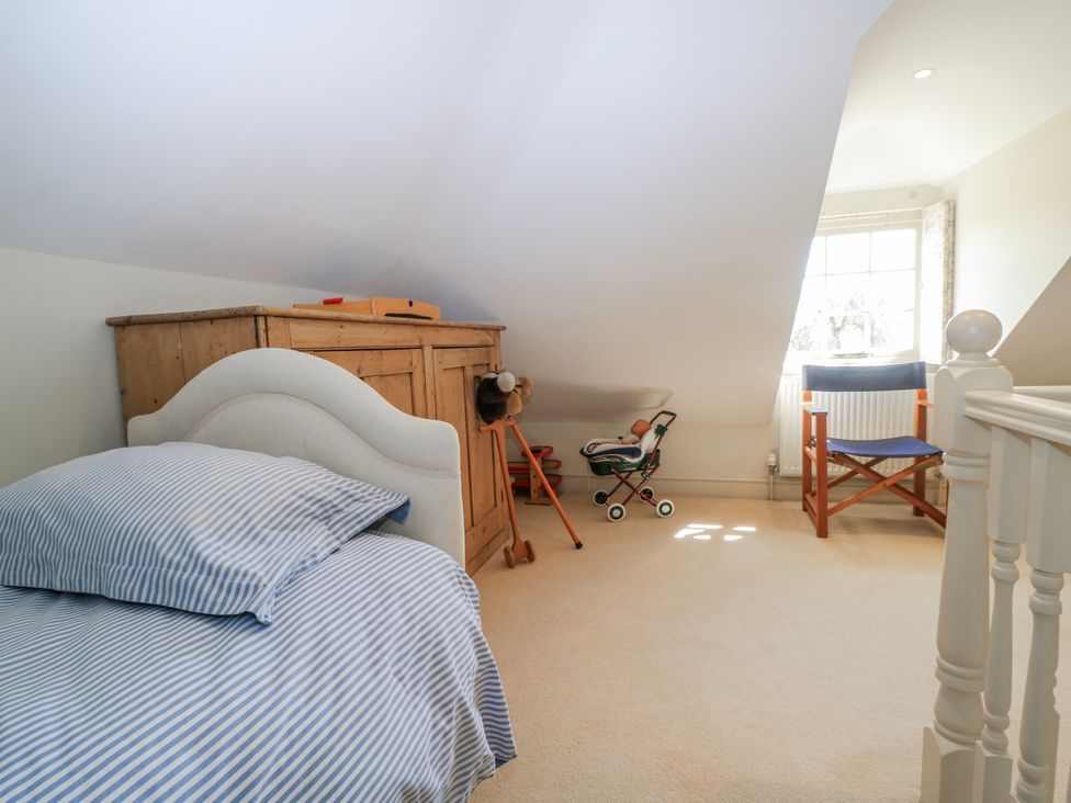 A bedroom with a bed and chest of drawers at New Barn in Broad Chalke