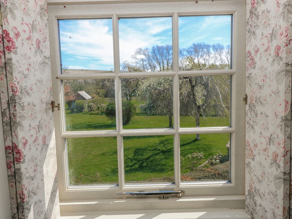 A window overlooking a garden at New Barn in Broad Chalke