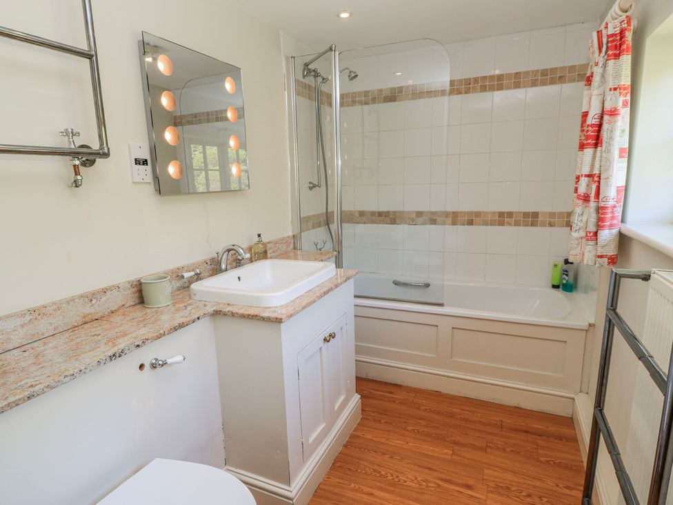 A bathroom with a sink and bathtub at New Barn in Broad Chalke