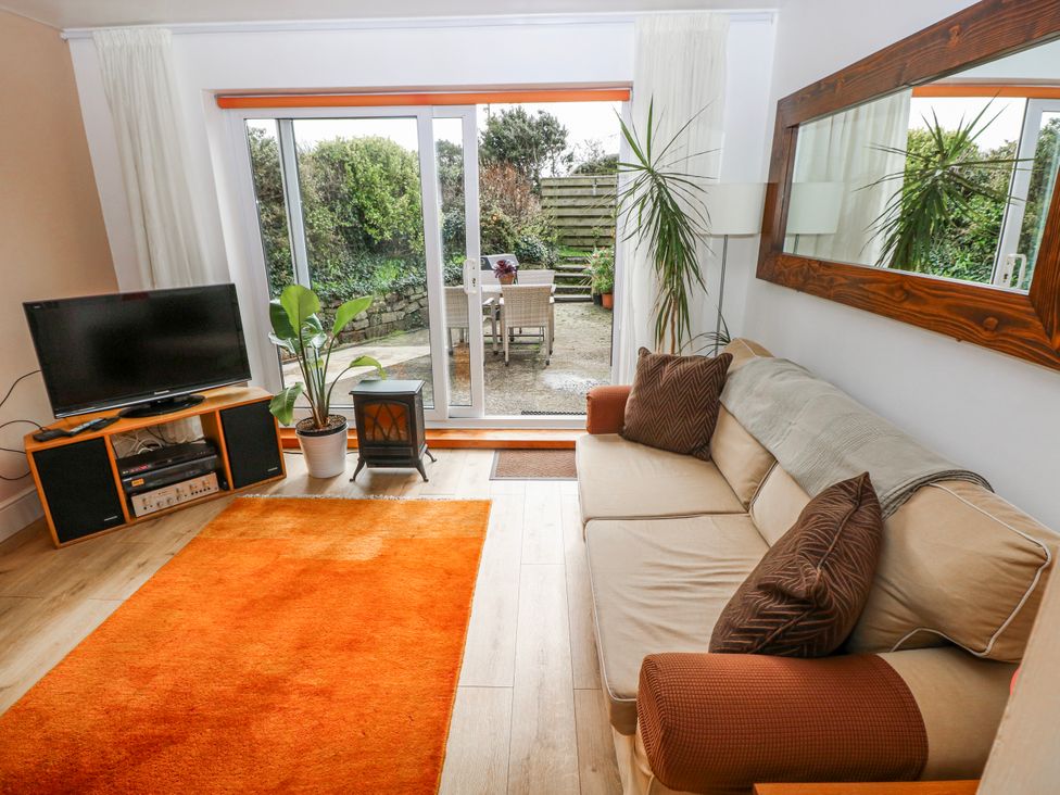 A living room with a sofa and television at The Cwtch in Haverfordwest