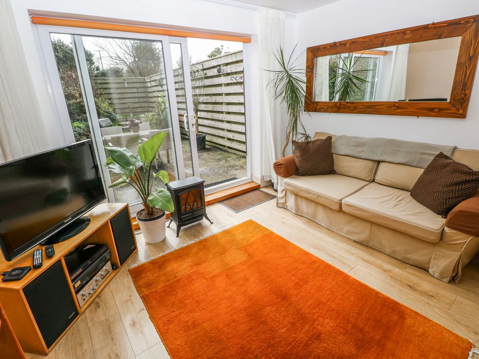 A living room with a sofa and television at The Cwtch in Haverfordwest