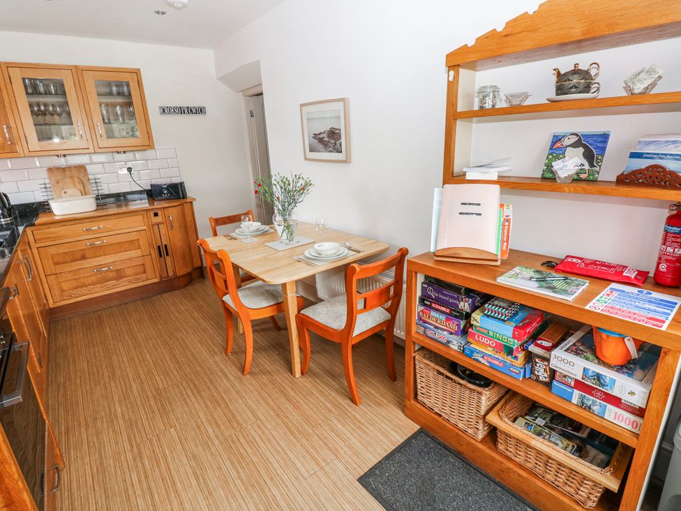 A kitchen with a table and chairs at The Cwtch in Haverfordwest