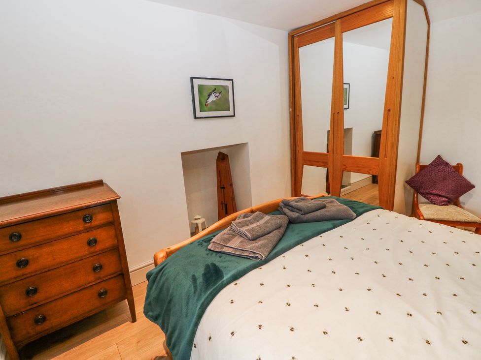 A bedroom with a bed and a chest of drawers at The Cwtch in Haverfordwest