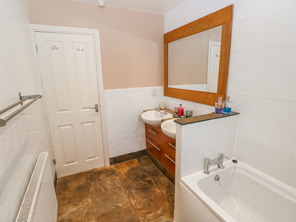 A bathroom with a sink and bathtub at The Cwtch in Haverfordwest