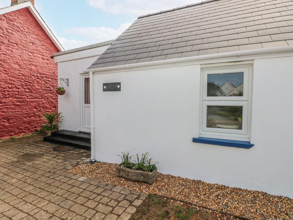 An outdoor area with a house and stone pavement at The Cwtch in Haverfordwest