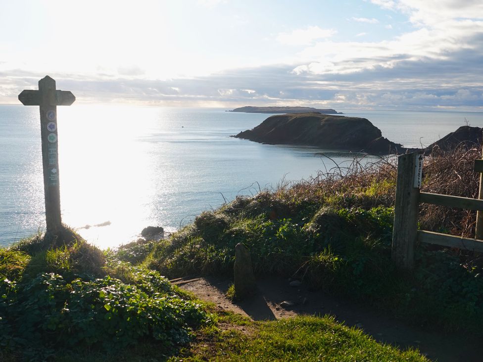 A view of the ocean and islands from a coastal path at The Cwtch in Marloes