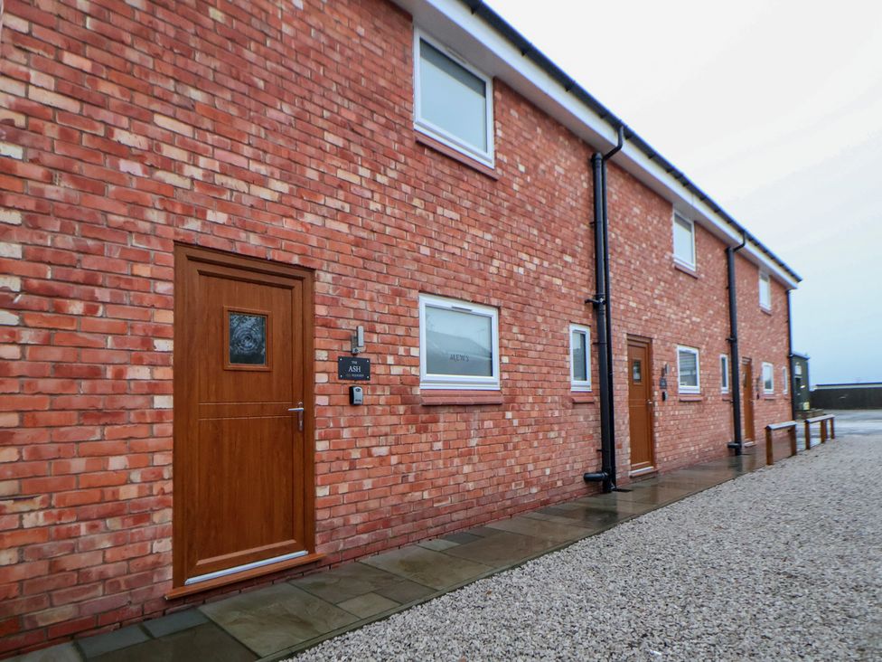 Exterior view of a brick building with doors and windows at Ash Barn in Chester