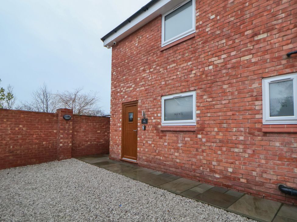 An exterior view of a brick house with a front door at Ash Barn Chester