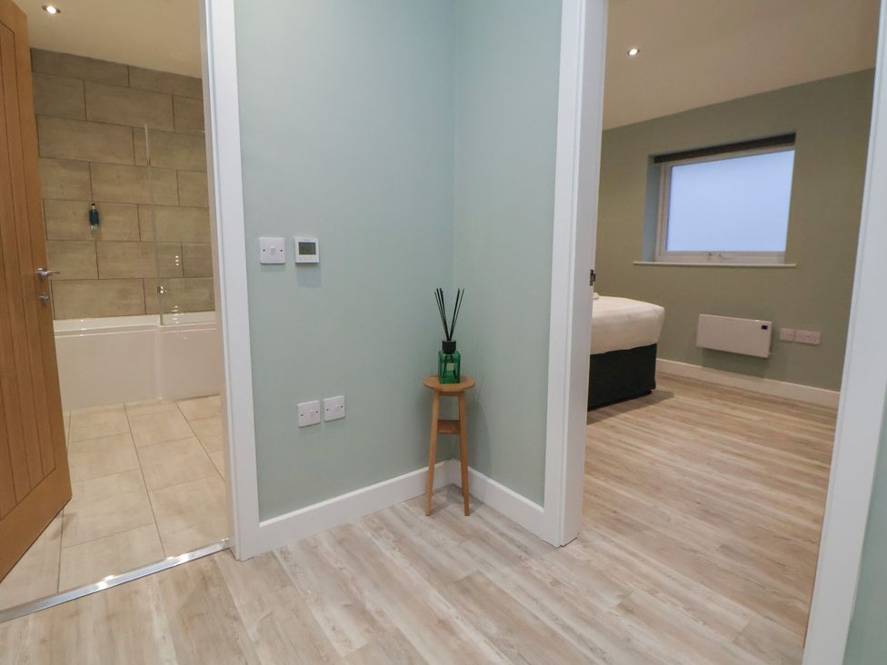 A bathroom with a bathtub and a plant at Ash Barn in Chester