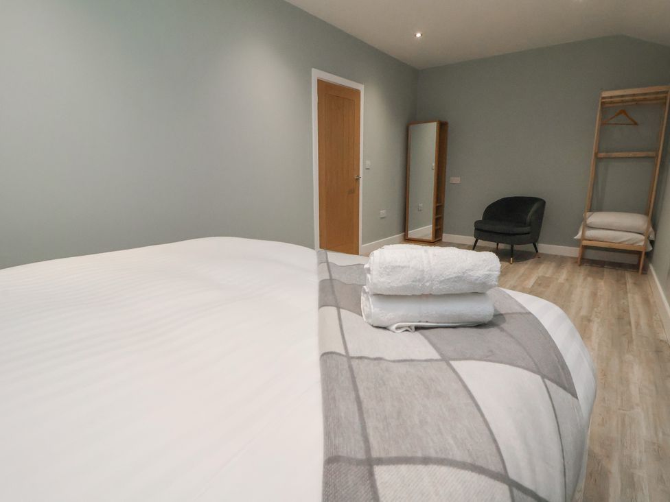 A bedroom with a bed and mirror at Ash Barn in Chester