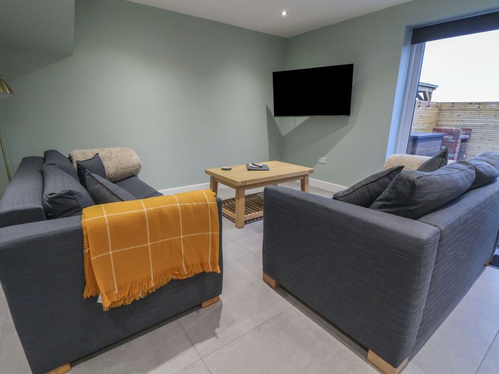 A living room with a television and seating area at Ash Barn in Saughall