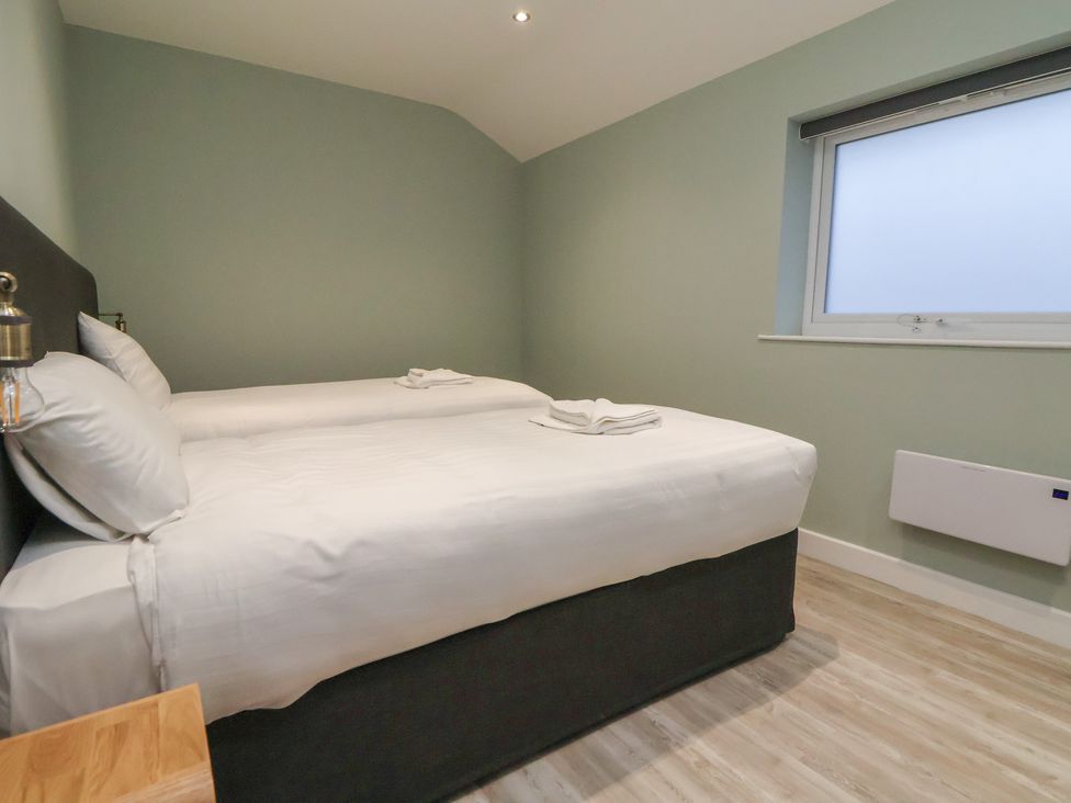 A bedroom with two beds and towels on them at Oak Barn in Chester