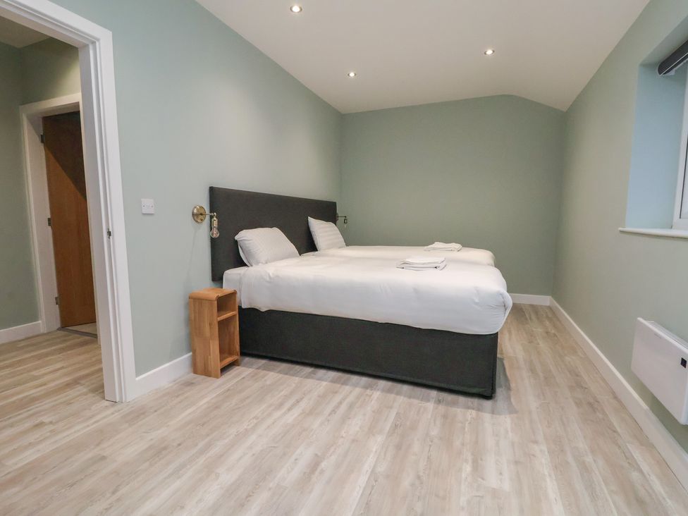 A bedroom with a bed and nightstand at Oak Barn in Chester