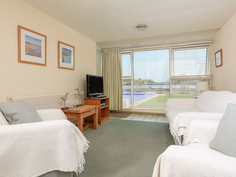 A living room with a sofa and television at 3 The Salcombe in Salcombe