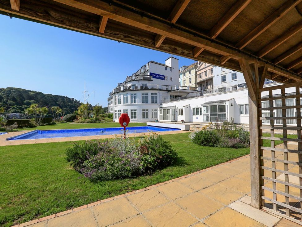 An outdoor area with a swimming pool and landscaping at 3 The Salcombe Salcombe