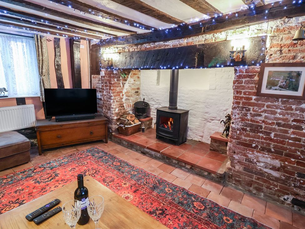 A living room with a tv and fireplace at Driftway Cottage Diss
